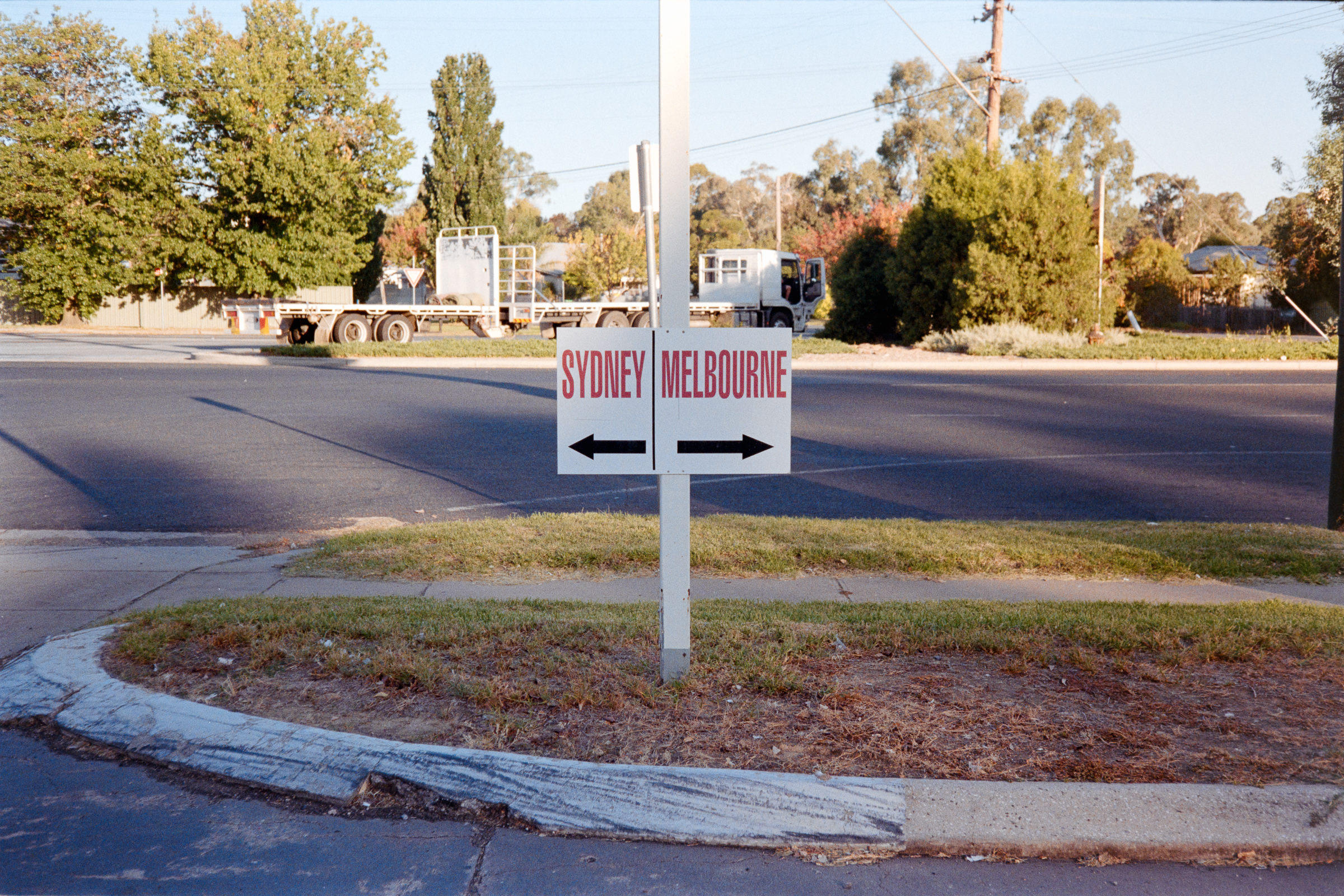Photos of a sign at a service station in Tarcutta - "←Sydney | Melbourne→" - Kodak Gold - Olympus 35RC